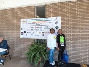 two women standing in front of sign