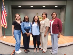 group of five women smiling