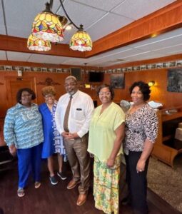 group of four woman and man smiling a church