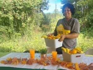 a woman holding a basket of fruit smiling