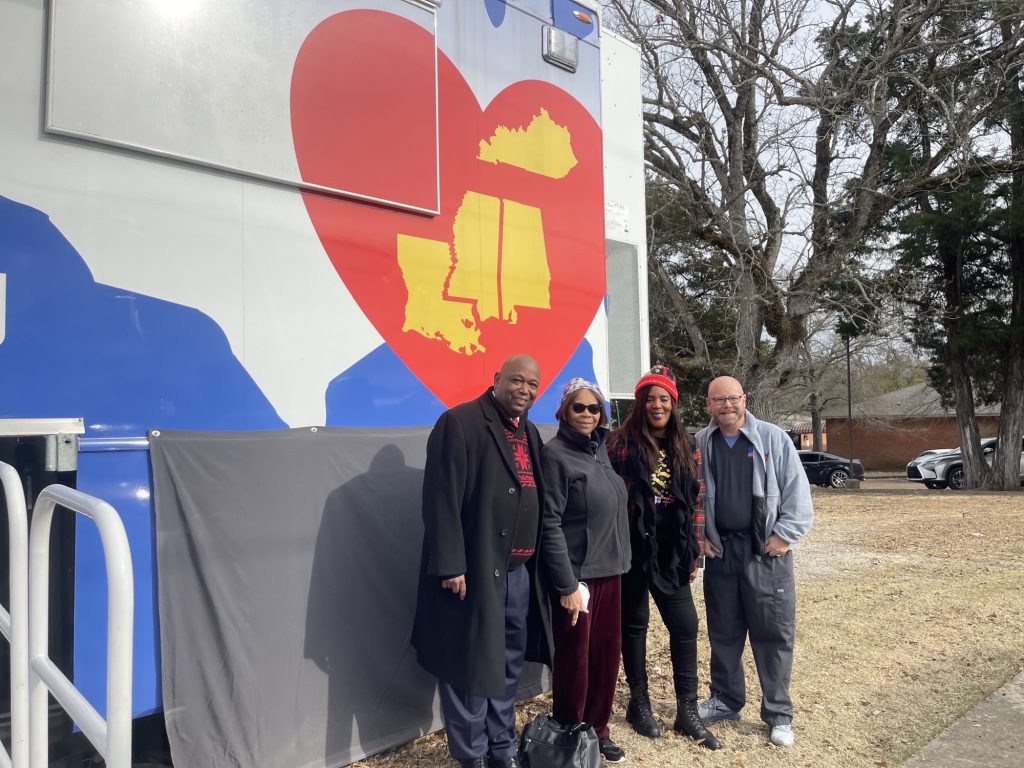 group of people in front of rural trailer