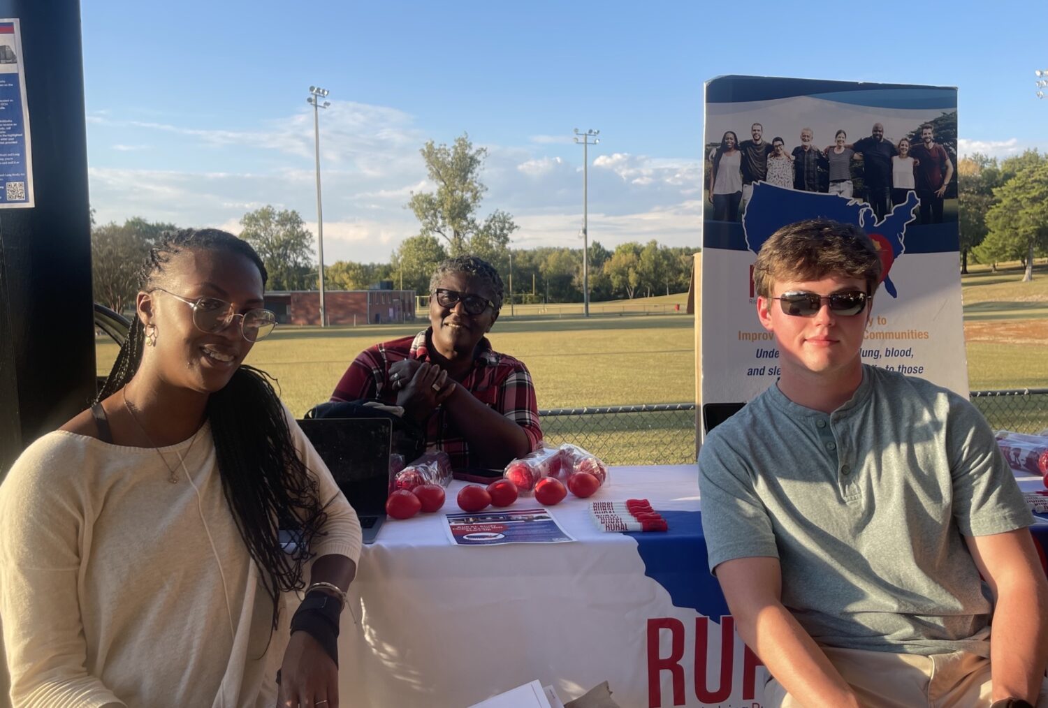 three people at rural table