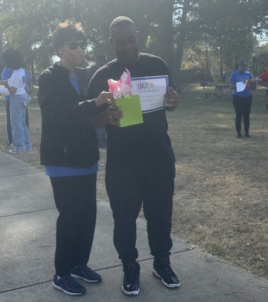 man and woman holding certificate