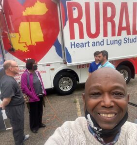 team standing in front of rural trailer