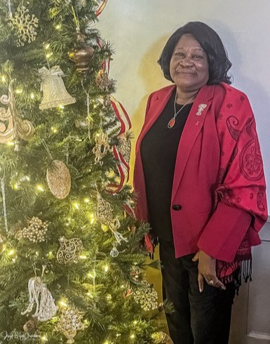woman standing next to christmas tree