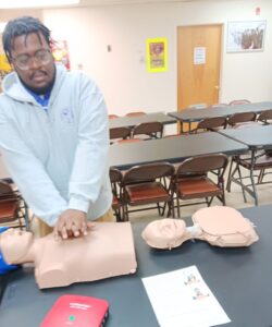 man performing cpr on dummy