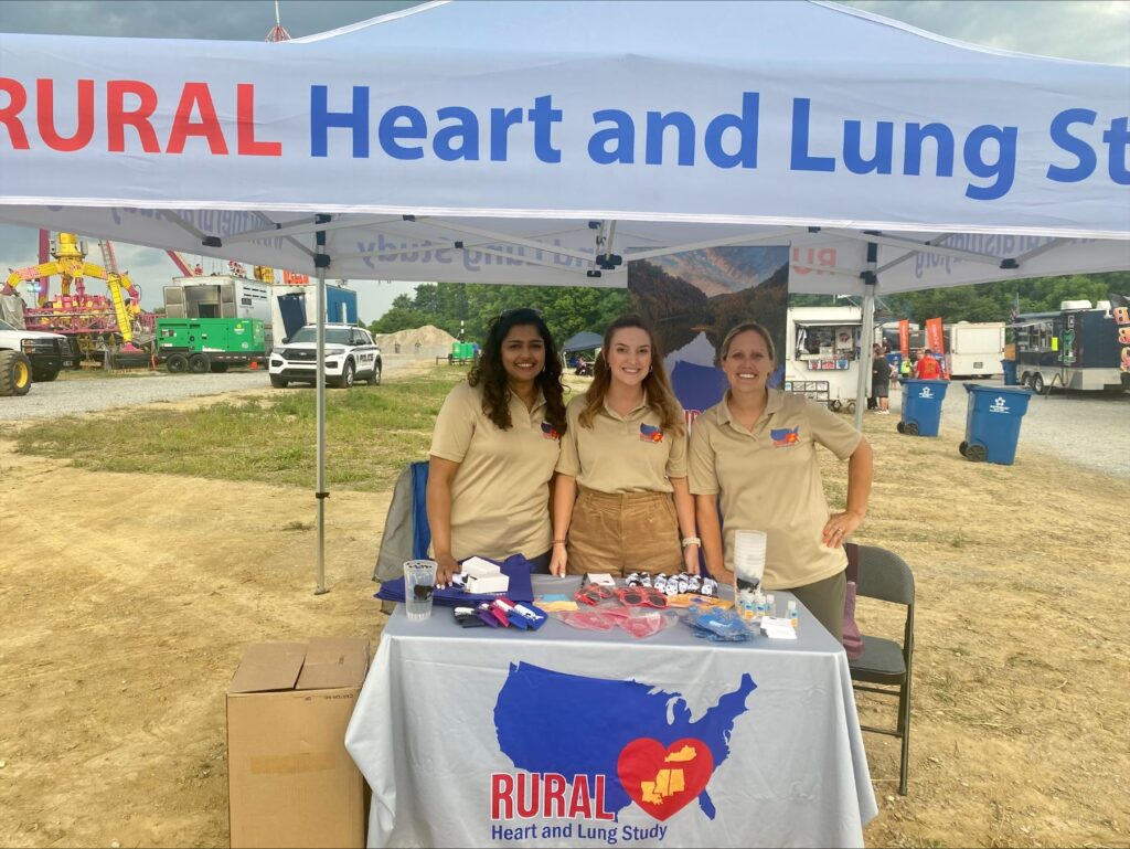 Stephie, Scotland, and Dr. Boone smiling at RURAL table