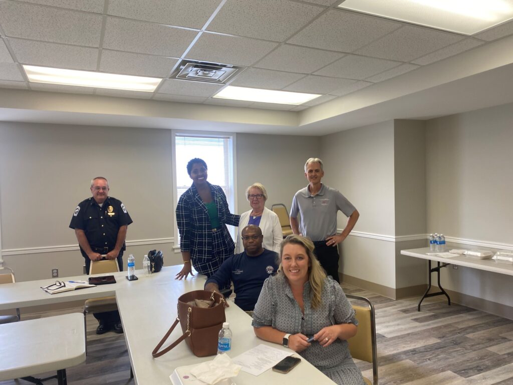 Community Advisory Board smiling at table