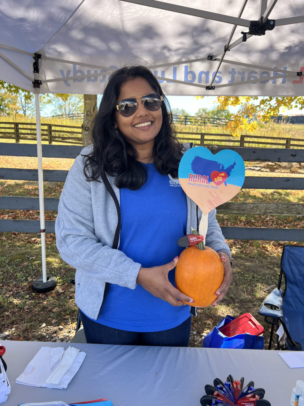 Stephie Abraham smiling holding pumpkin