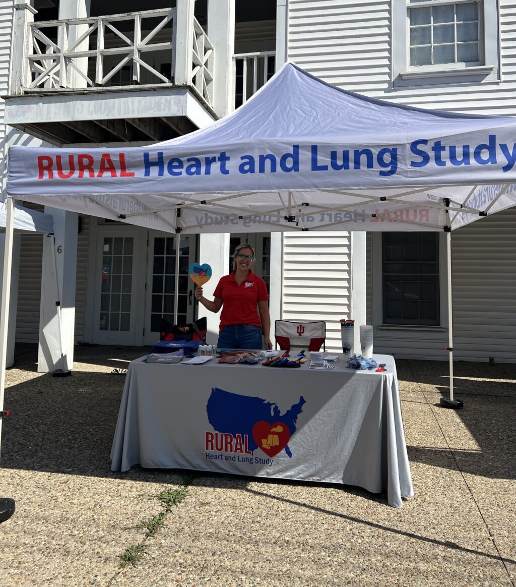RURAL staff member smiling at RURAL table